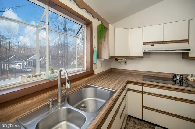 a kitchen with stainless steel appliances a refrigerator and a sink