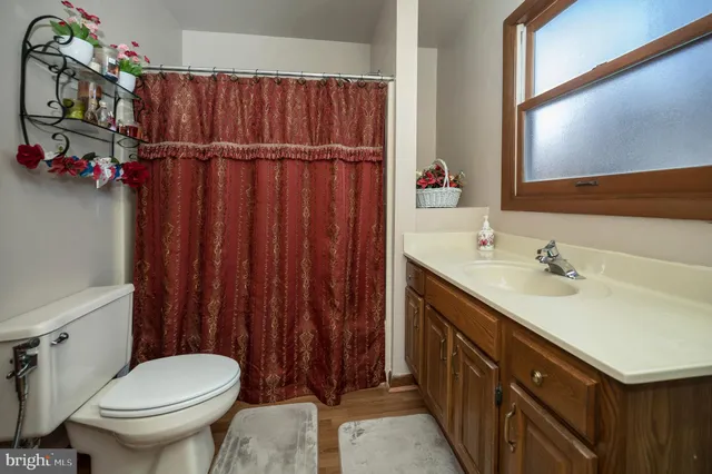 a bedroom with a bed and a chair with the potted plant