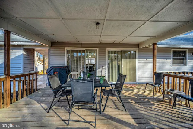 a view of a house with a yard and sitting area