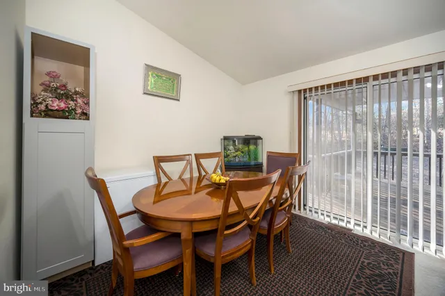 a dining room with furniture and wooden floor