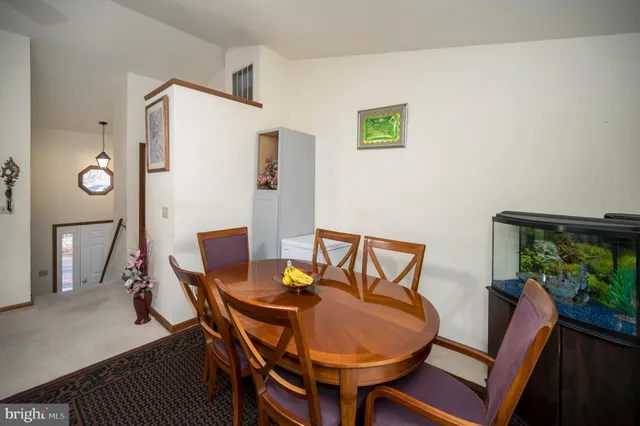 a view of a dining room with furniture and a potted plant