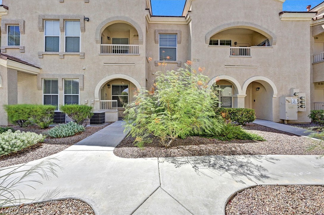 10550 West Alexander Road, Unit 1097 Las Vegas, NV 89129 - Photo 19 of 37 Stucco exteriors and arched entryways highlight this multi-level residential design.
