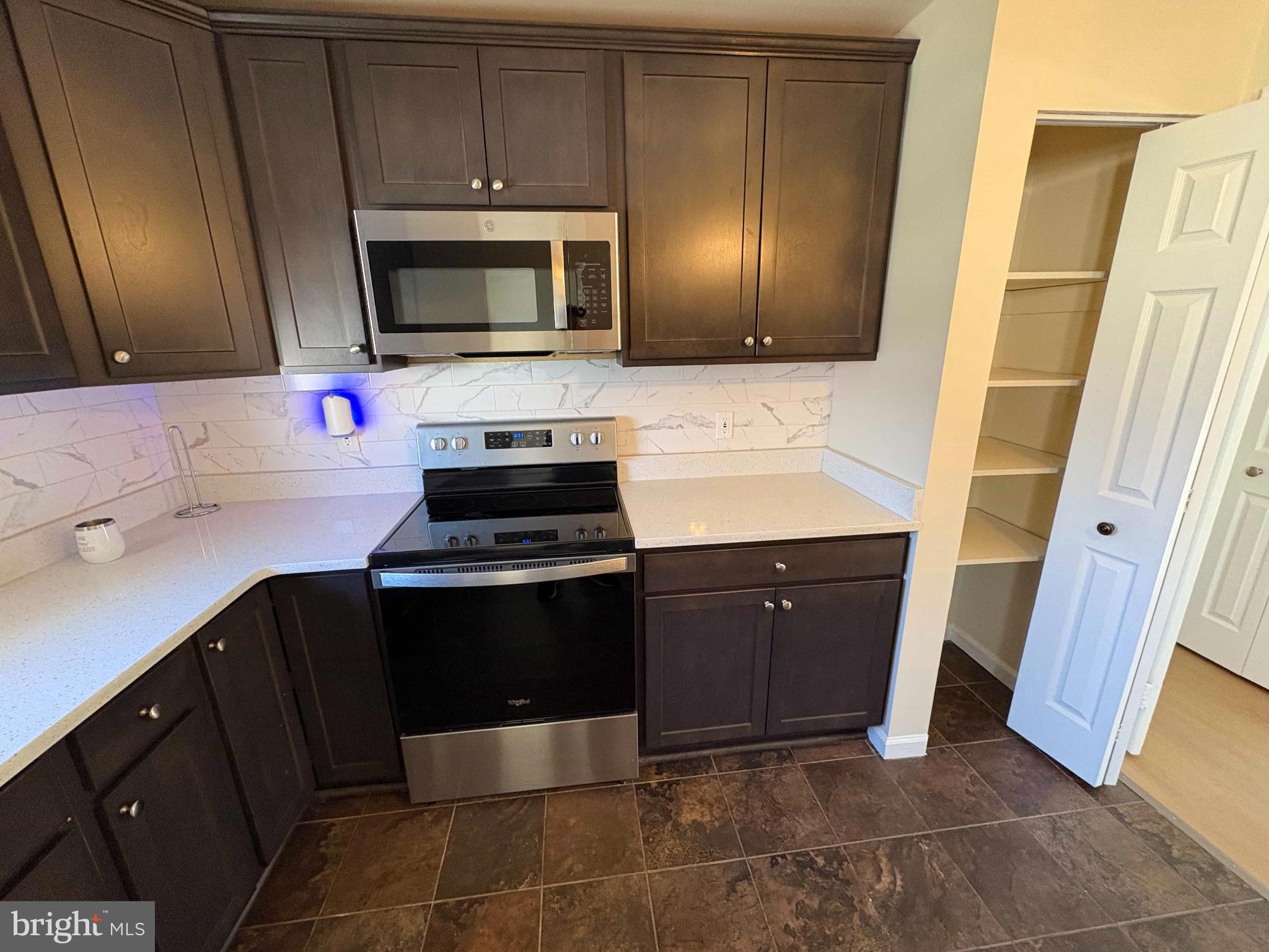 8716 Stephanie Road Randallstown, MD 21133 - Photo 3 of 19 Modern kitchen with sleek finishes.