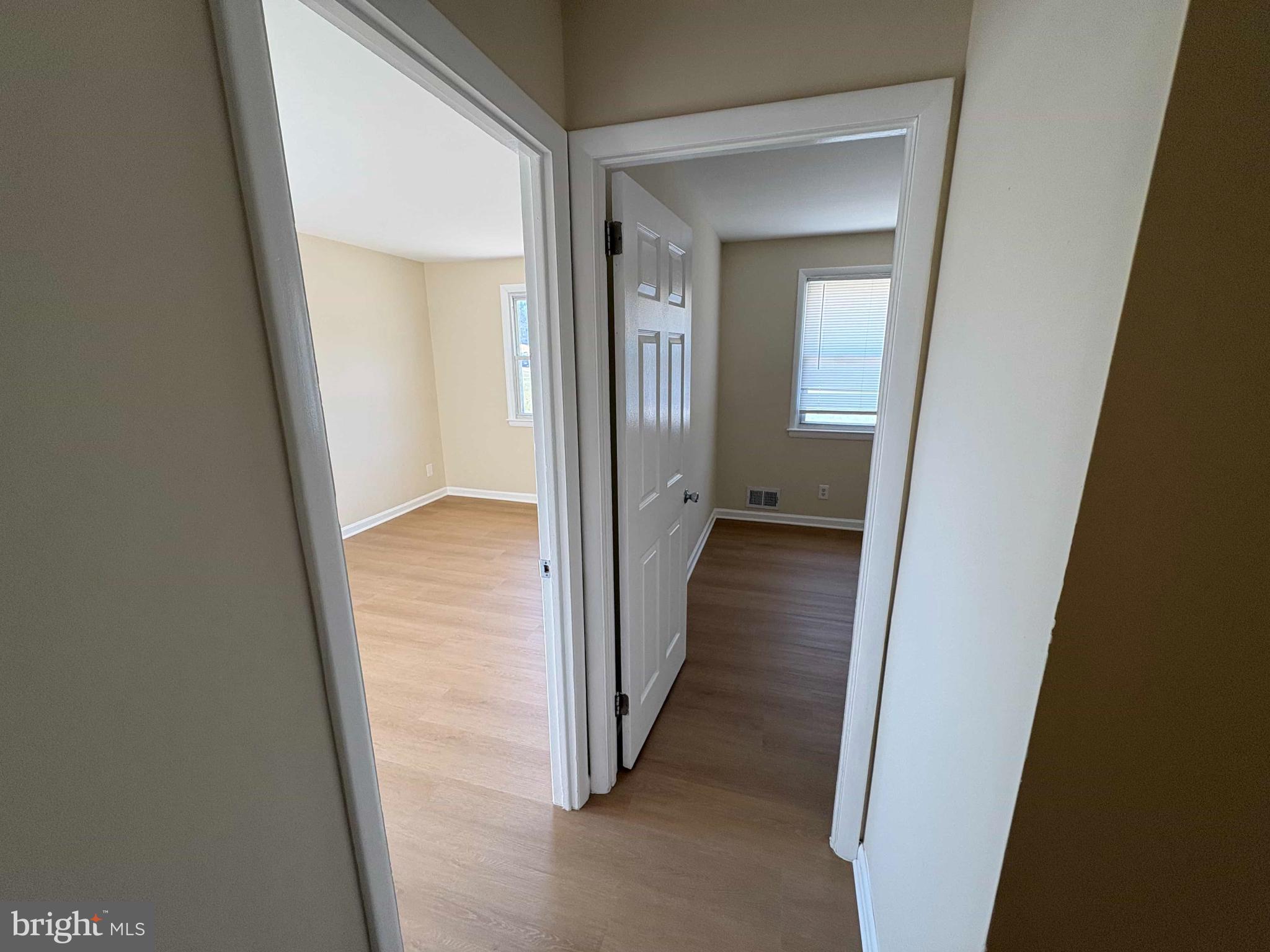 8716 Stephanie Road Randallstown, MD 21133 - Photo 5 of 19 Bright and inviting hallway with open doors.