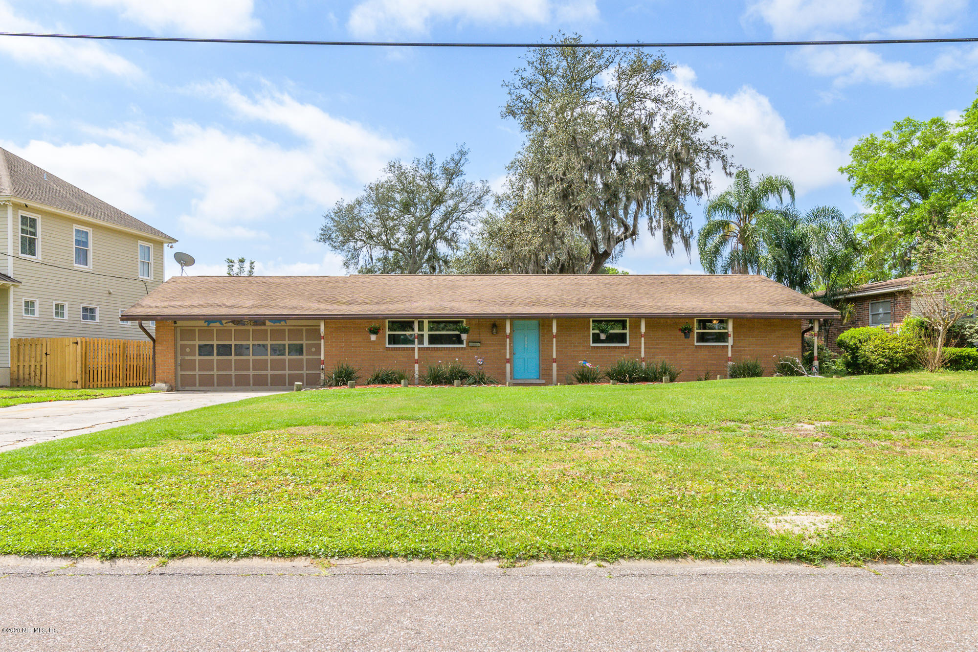 256 Baisden Road Jacksonville, FL 32218 - Photo 1 of 26 a view of a house with a big yard and large trees