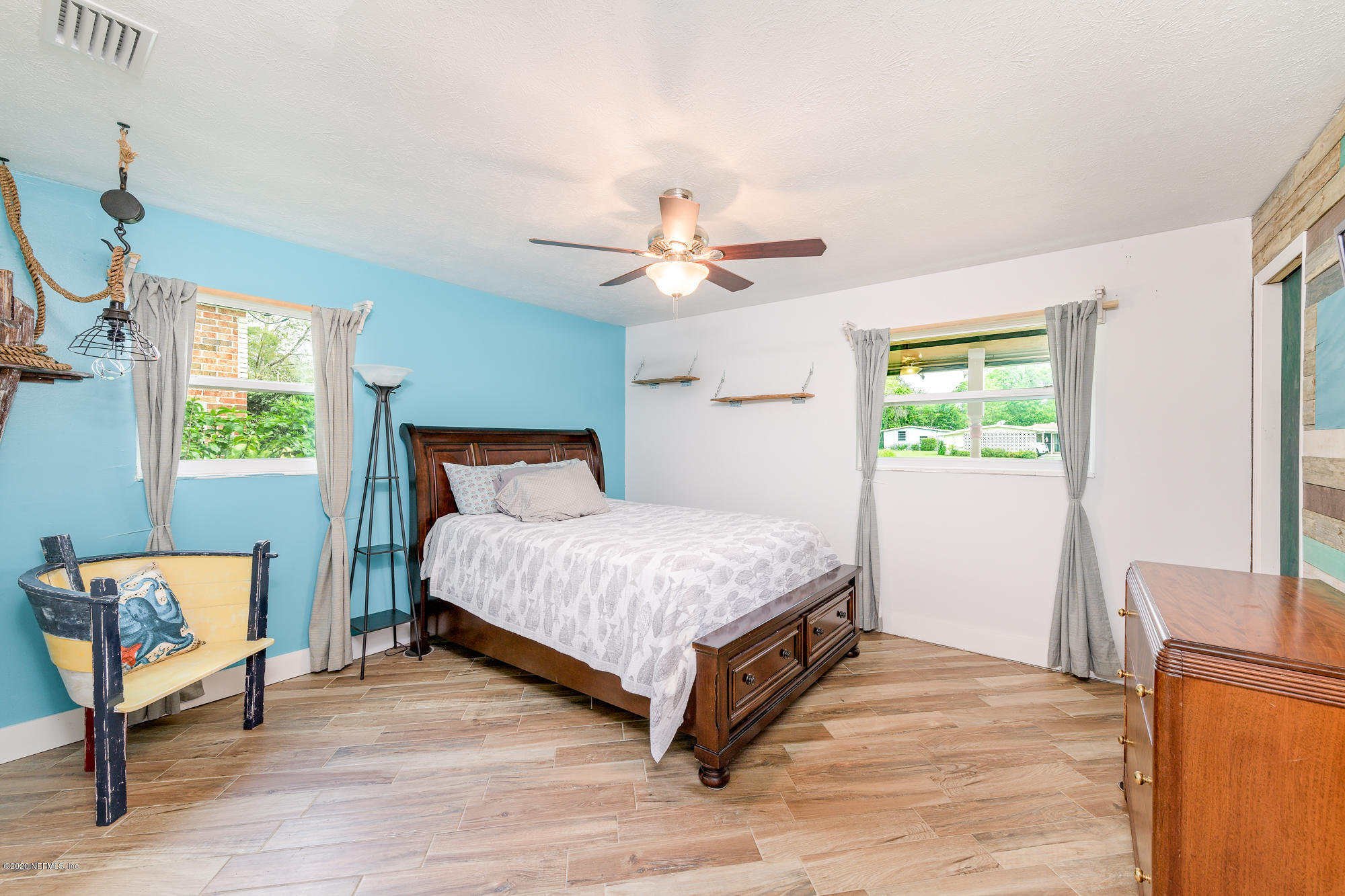 256 Baisden Road Jacksonville, FL 32218 - Photo 19 of 26 a bedroom with a bed and a chandelier