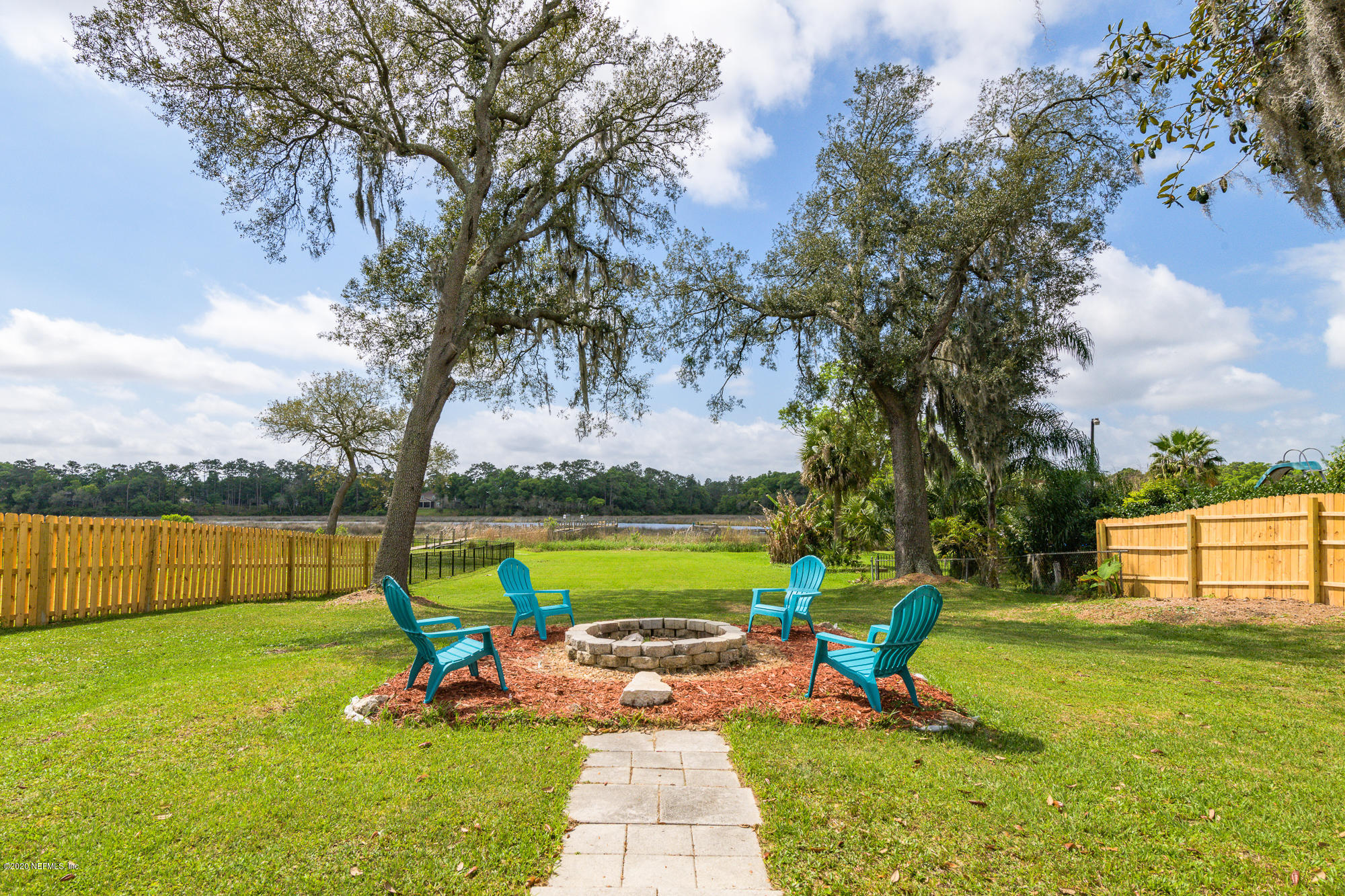 256 Baisden Road Jacksonville, FL 32218 - Photo 20 of 26 a view of a lake with a yard and a large tree