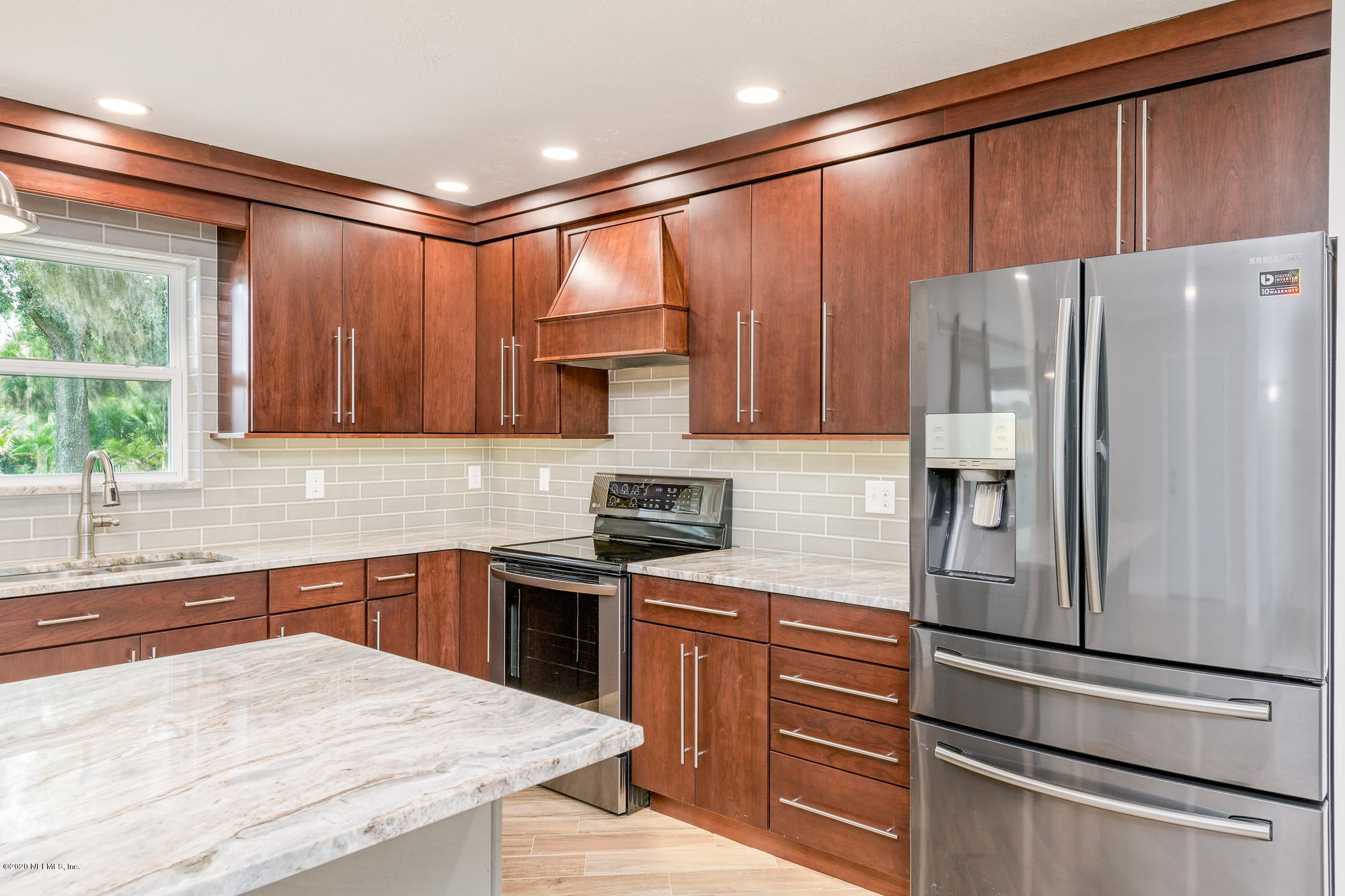 256 Baisden Road Jacksonville, FL 32218 - Photo 6 of 26 a kitchen with stainless steel appliances granite countertop a refrigerator sink and cabinets