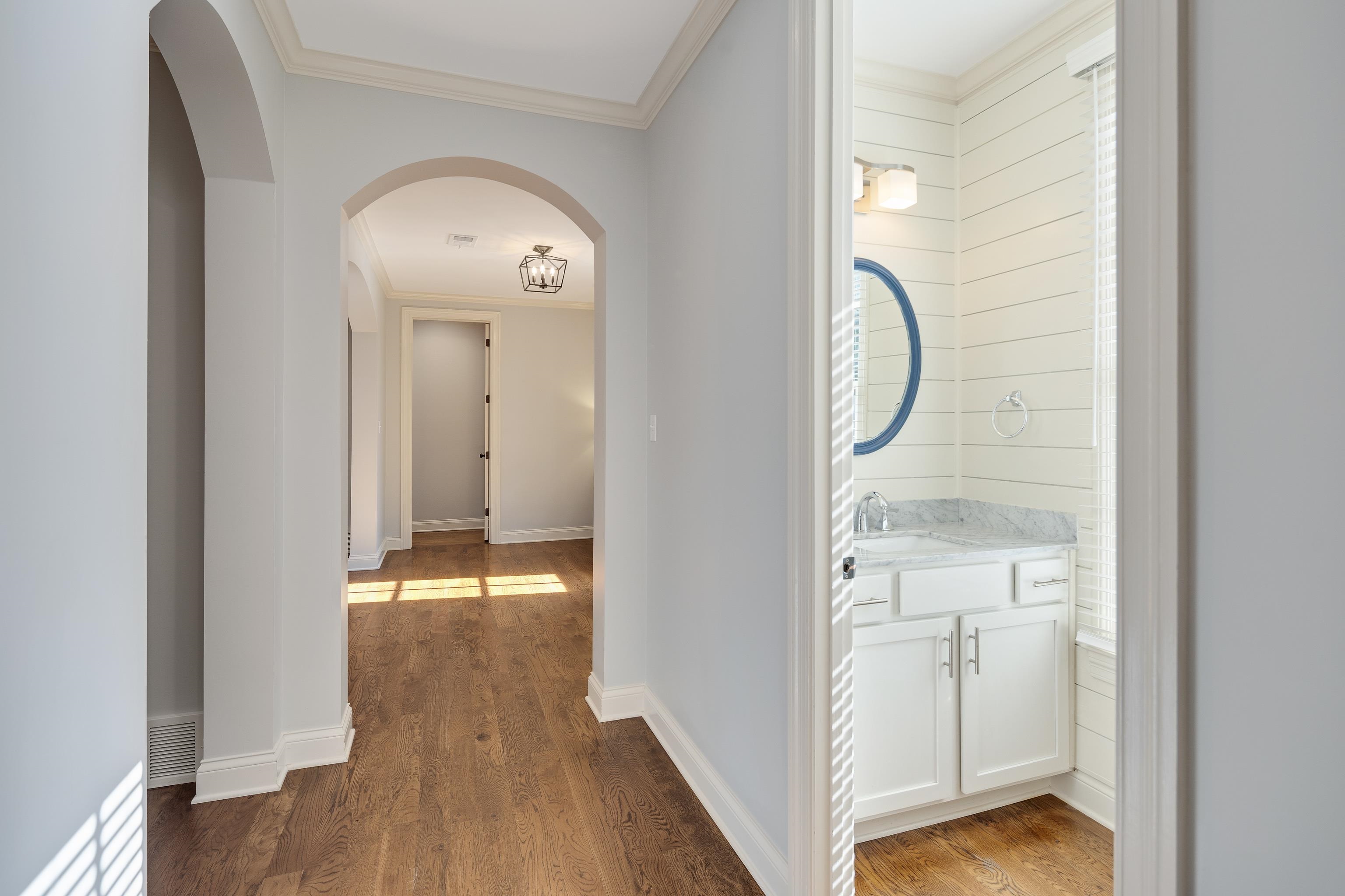 237 Windover Road Memphis, TN 38111 - Photo 15 of 37 Hall featuring arched walkways, ornamental molding, and light wood finished floors
