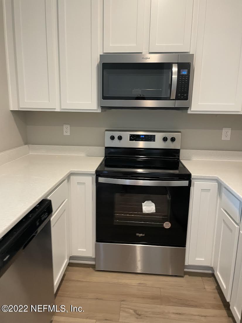 a kitchen with a stove and a microwave