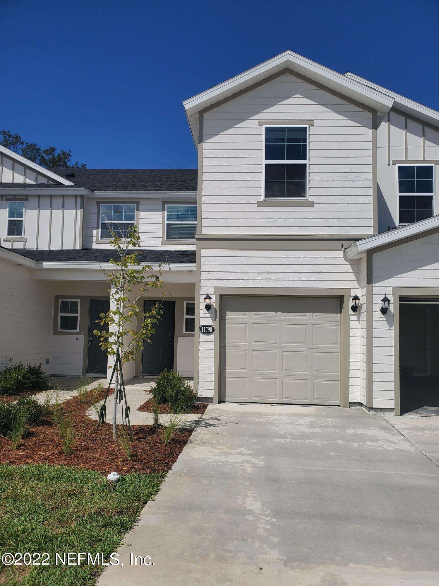 11792 Junegrass Road Jacksonville, FL 32258 - Photo 2 of 16 a front view of a house with garden
