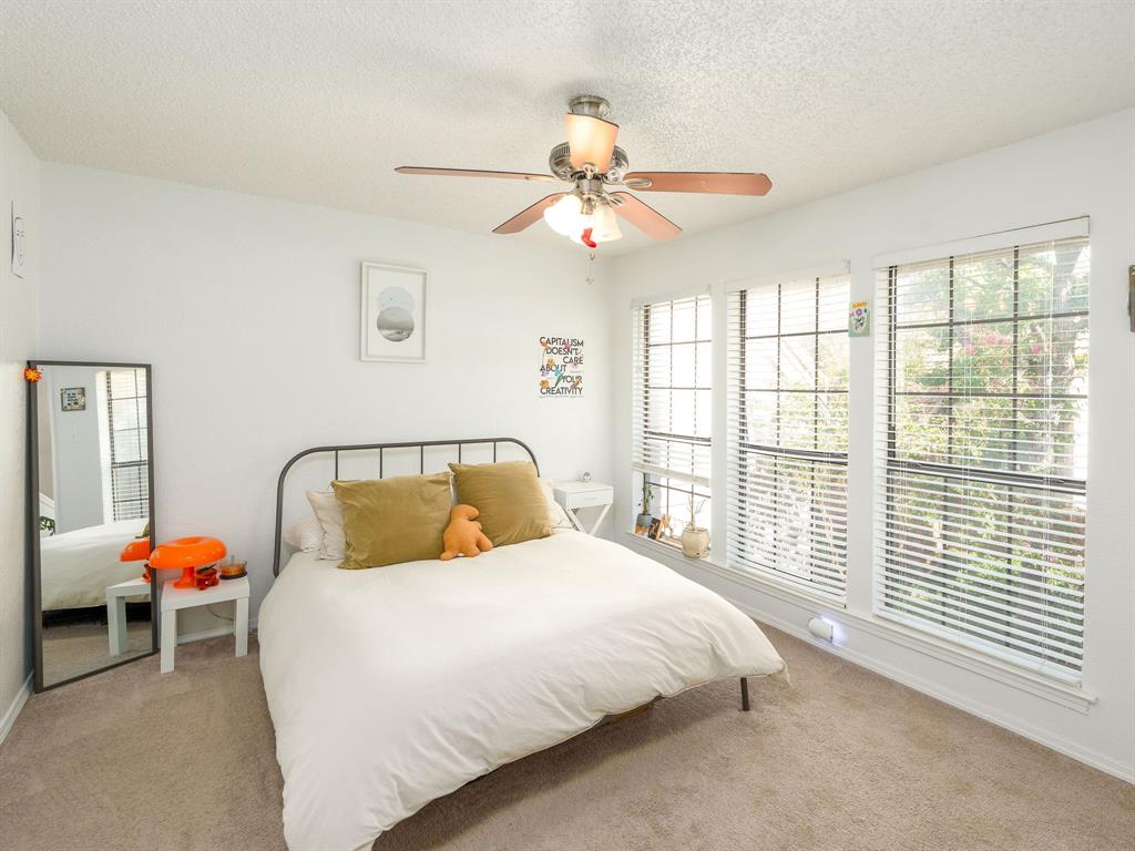 18240 Midway Road, Unit 205 Dallas, TX 75287 - Photo 13 of 27 a bedroom with a bed and a window