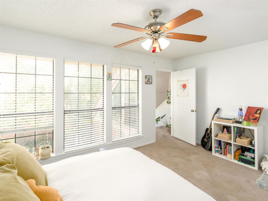 18240 Midway Road, Unit 205 Dallas, TX 75287 - Photo 14 of 27 a spacious bedroom with a bed and a large window