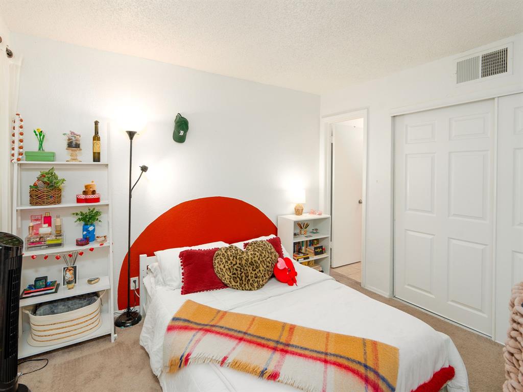 18240 Midway Road, Unit 205 Dallas, TX 75287 - Photo 18 of 27 a bedroom with a bed and a window