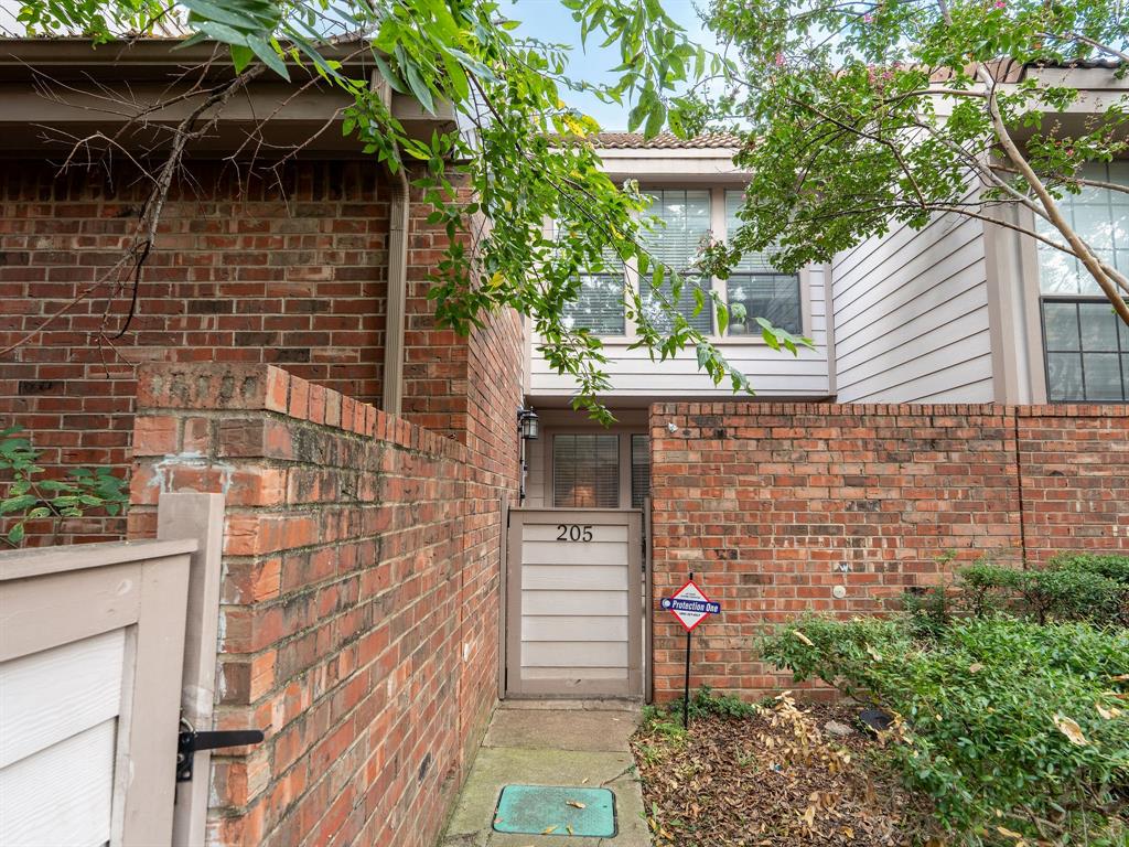 18240 Midway Road, Unit 205 Dallas, TX 75287 - Photo 2 of 27 a backyard of a house with an outdoor space and seating area