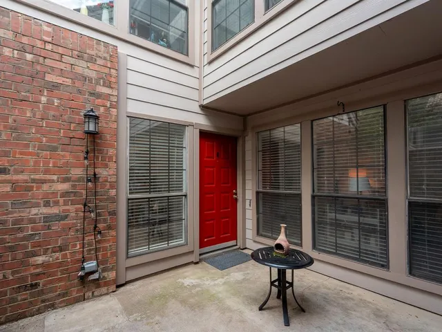 a room with pool table and windows