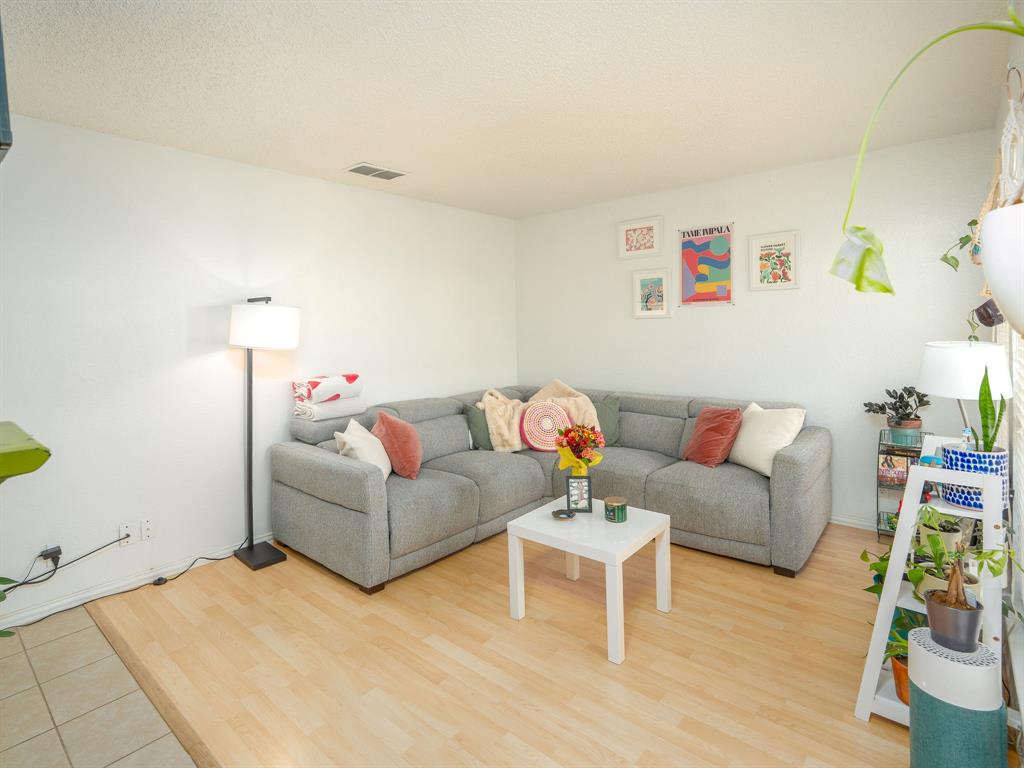 18240 Midway Road, Unit 205 Dallas, TX 75287 - Photo 4 of 27 a living room with furniture and a wooden floor