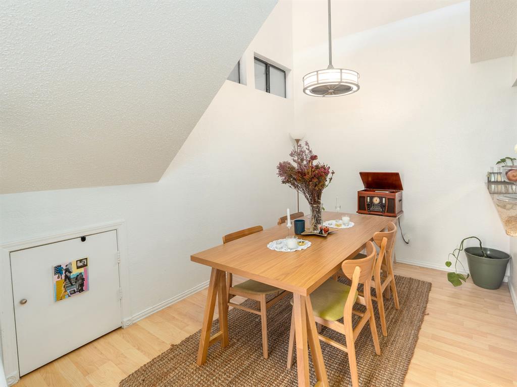 18240 Midway Road, Unit 205 Dallas, TX 75287 - Photo 8 of 27 a view of a dining room with furniture and wooden floor