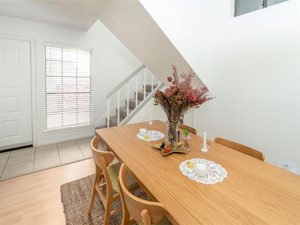 18240 Midway Road, Unit 205 Dallas, TX 75287 - Photo 9 of 27 a view of a dining room with furniture and wooden floor