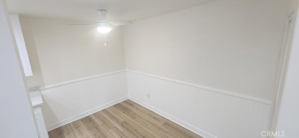 1030 West MacArthur Boulevard, Unit 51 Santa Ana, CA 92707 - Photo 18 of 34 dining area has a ceiling fan & wainscoting