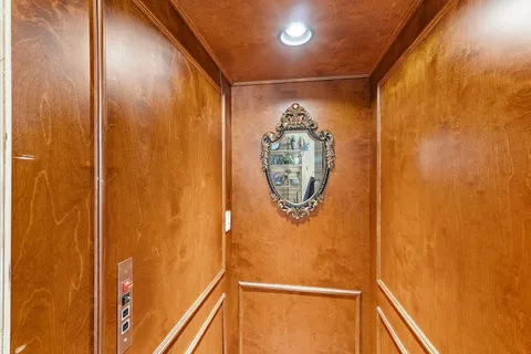 a bedroom with natural light and wooden floor