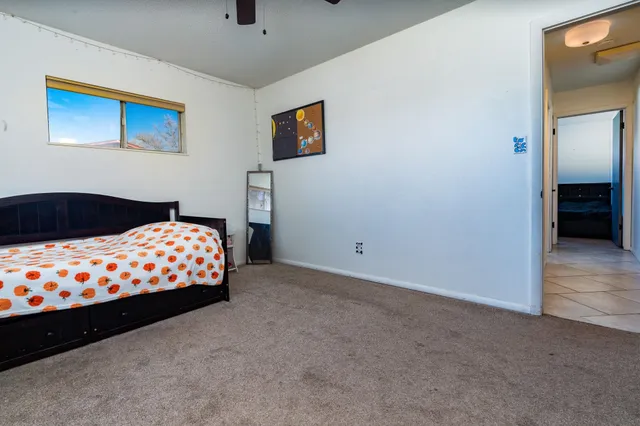 a bedroom with bed and window