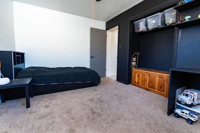 a bedroom with a bed and a television