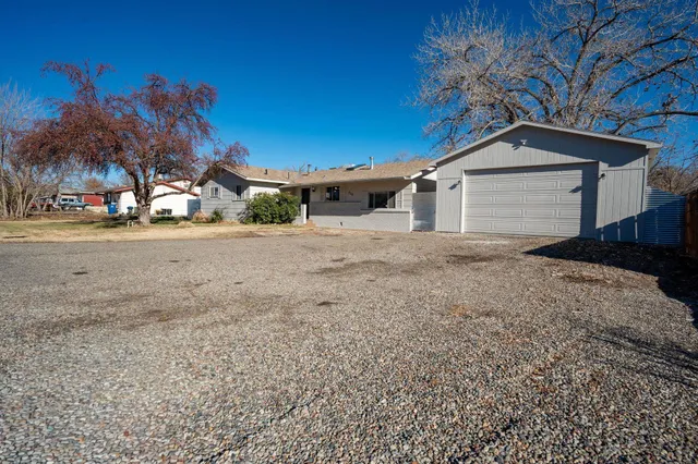 a view of a house with a yard and garage