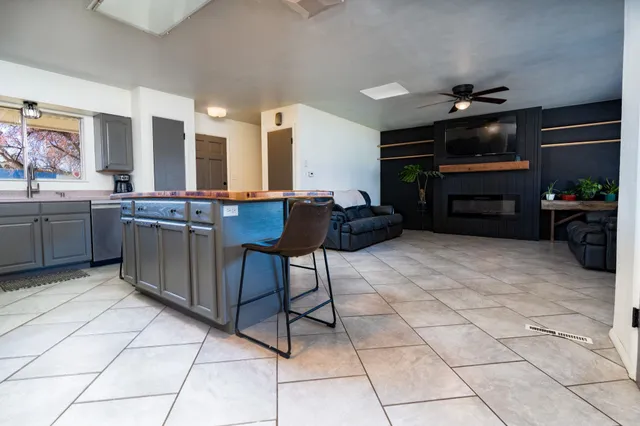 a view of kitchen with furniture and electronic appliances