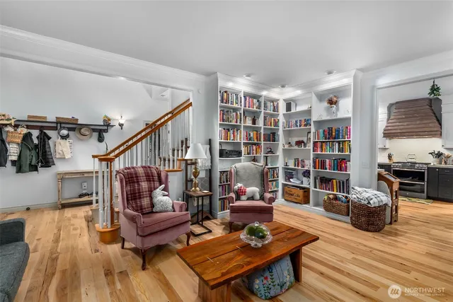 a living room with furniture and a book shelf