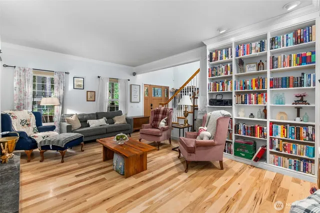 a living room with furniture and a book shelf