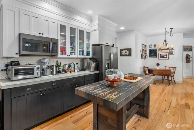 a kitchen with stainless steel appliances granite countertop a stove refrigerator sink and microwave