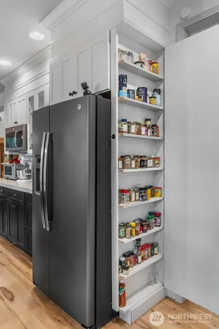 a metallic refrigerator freezer sitting in a kitchen
