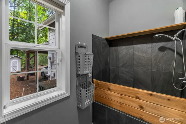 a bathroom with a shower and a sink