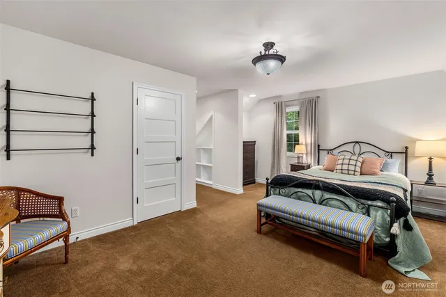 a view of a bedroom with furniture and a ceiling fan
