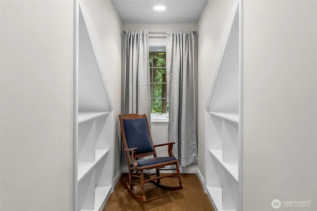 a view of a workspace with furniture and a window