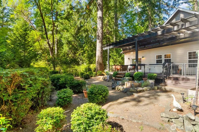 a view of backyard with outdoor seating and plants