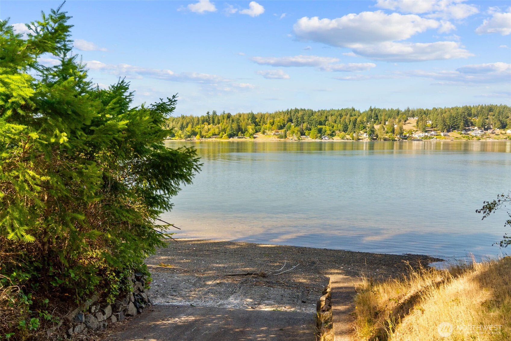 1130 East Sunset Hill Road Shelton, WA 98584 - Photo 39 of 40 a view of a lake with boats and trees in the background