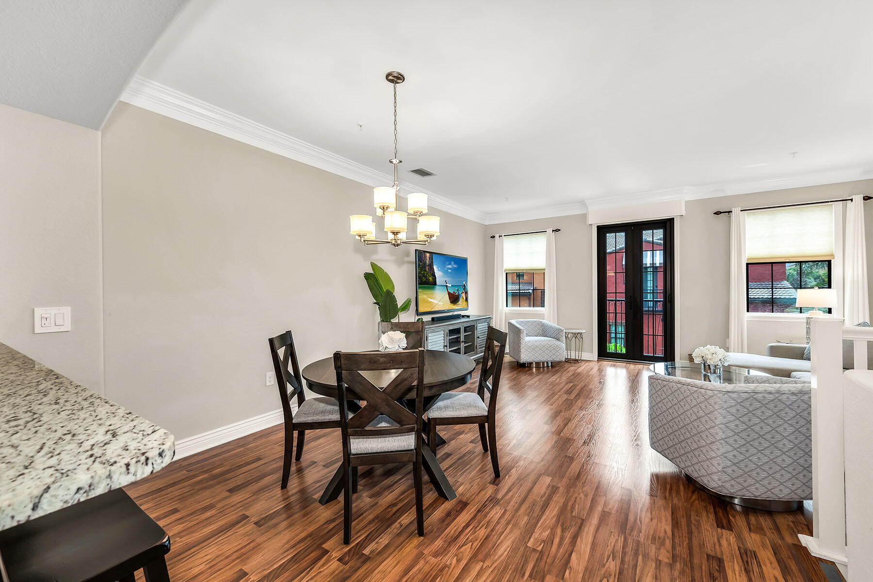 9066 Albion Lane North, Unit 5101 Naples, FL 34113 - Photo 7 of 48 a view of a dining room with furniture and wooden floor