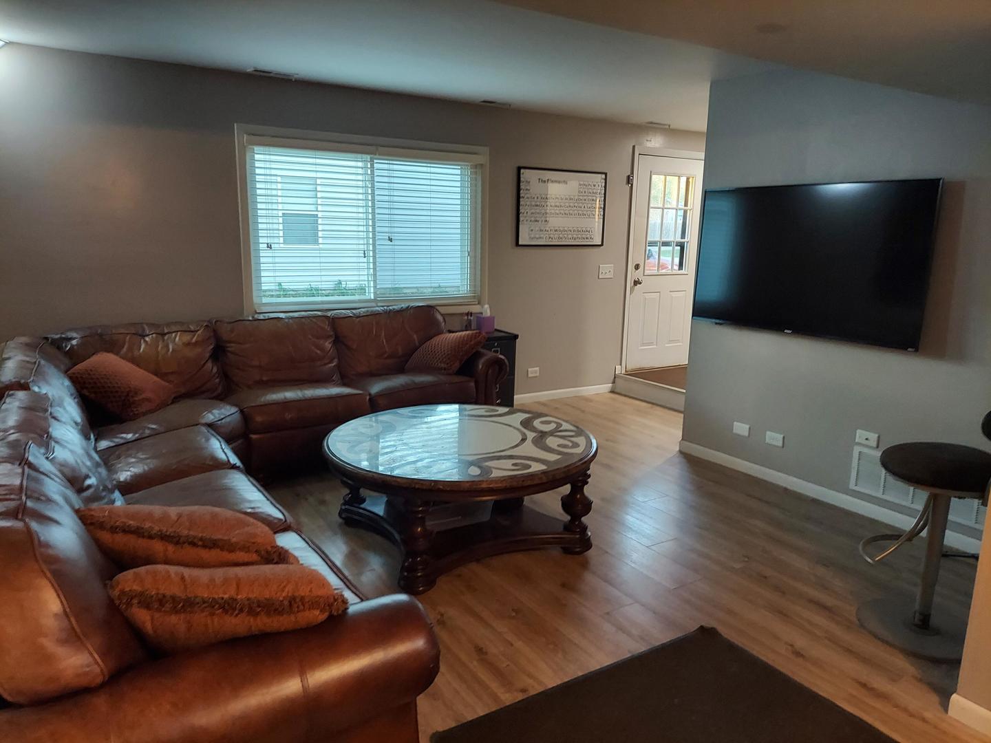 34W951 Stanton Drive, Unit G St. Charles, IL 60174 - Photo 3 of 11 a living room with furniture and a flat screen tv