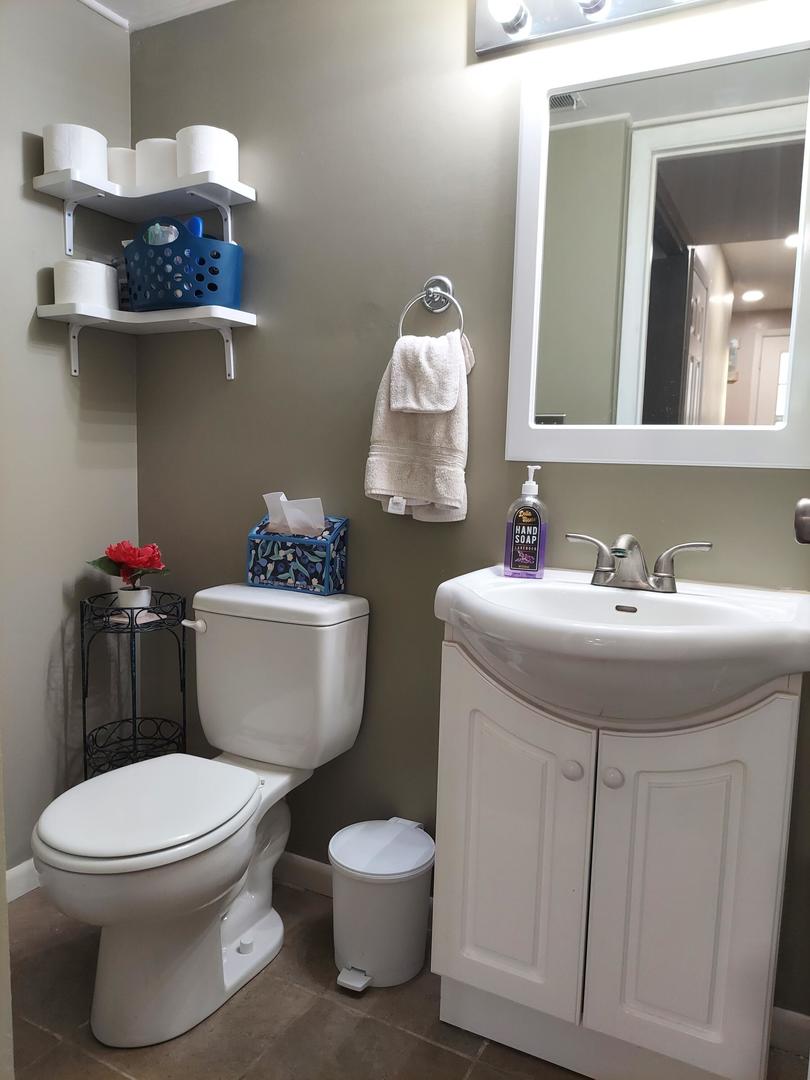34W951 Stanton Drive, Unit G St. Charles, IL 60174 - Photo 4 of 11 a bathroom with a toilet sink and mirror
