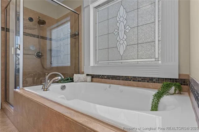 a living room with a large window and a chandelier