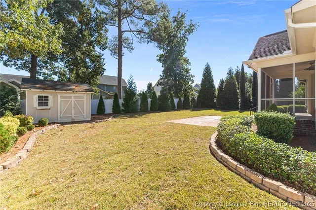 a front view of a house with a yard and potted plants