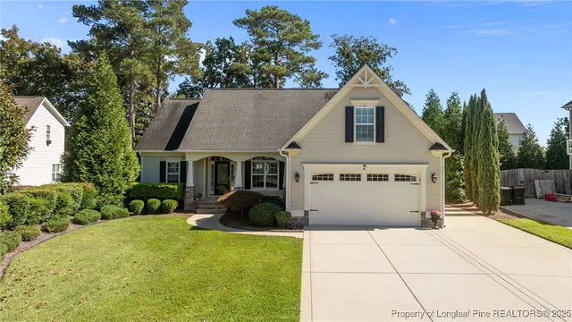 an aerial view of residential houses with outdoor space and parking