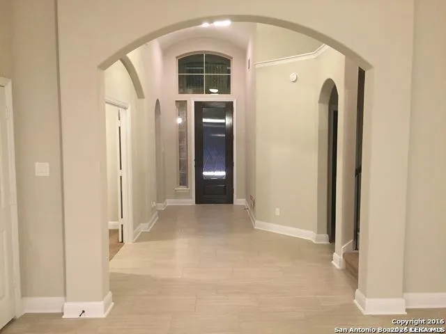 a view of a hallway with wooden shelves