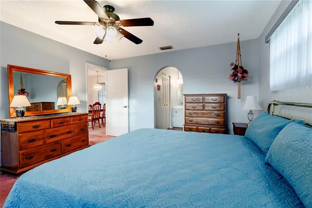 a bedroom with furniture and a chandelier
