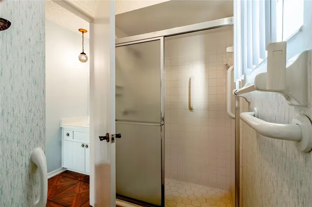 a bathroom with a shower and a mirror