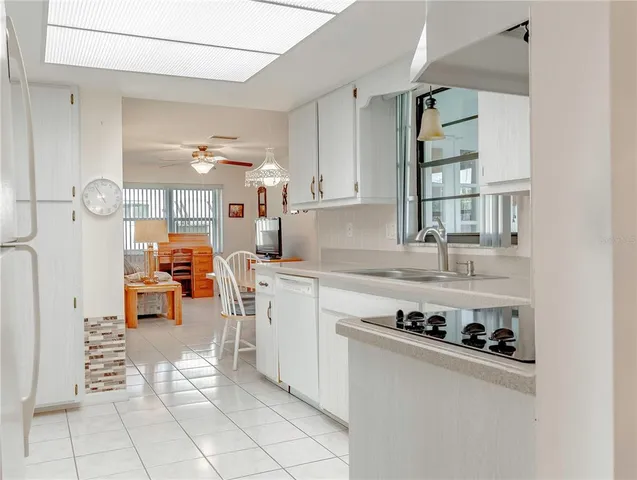 a kitchen with stainless steel appliances granite countertop a sink and cabinets