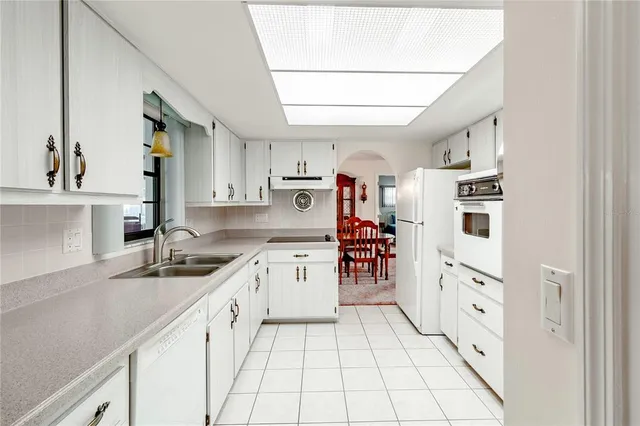 a kitchen with granite countertop a sink and cabinets