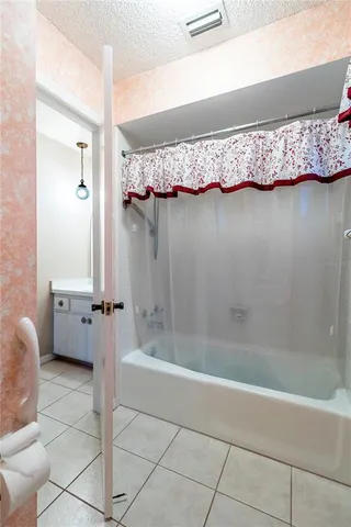 a bathroom with a tub and shower